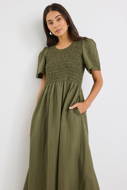 model wears a khaki linen midi dress