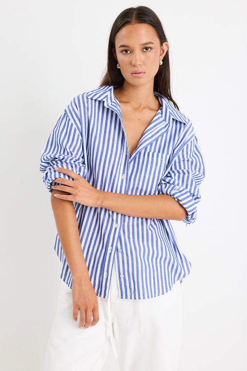 model wears cotton blue and white stripe shirt with white jeans