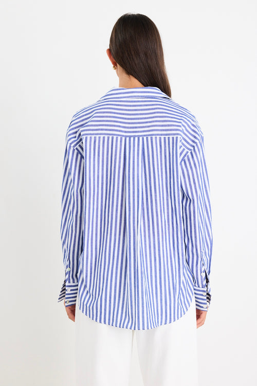 model wears cotton blue and white stripe shirt with white jeans