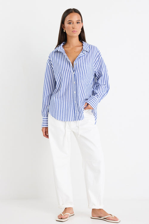 model wears cotton blue and white stripe shirt with white jeans