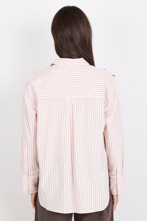 Person wearing a striped shirt and brown pants on a white background