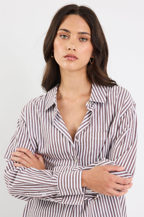 Woman wearing a striped shirt with a white background