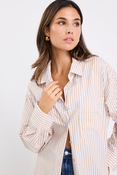Model wears a stripe white and tan shirt 
