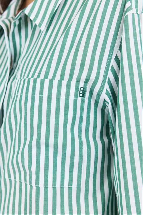 Green and white striped shirt with a brand logo on the chest pocket.