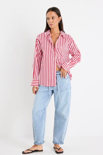 Model wears red stripe shirt and light blue jeans