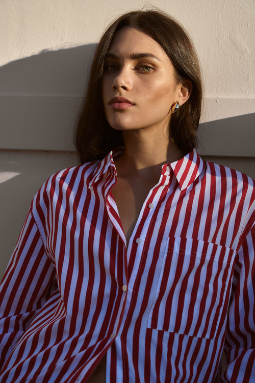 model wears red striped shirt