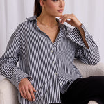 model wears a black and white stripe shirt 