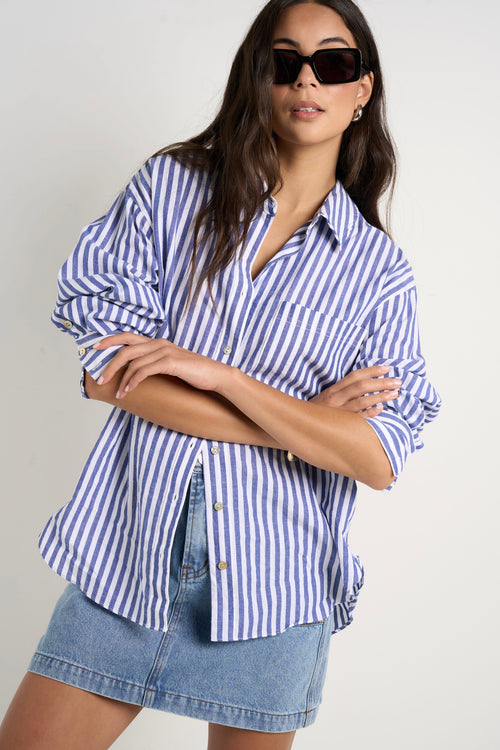 Model wears blue stripe shirt 