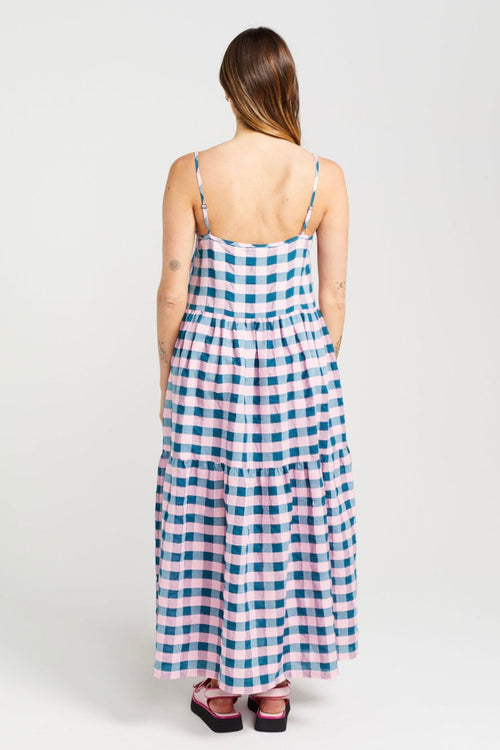 model wears blue and pink check maxi dress