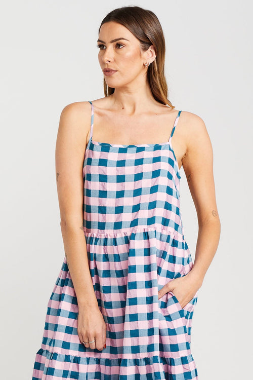 model wears blue and pink check maxi dress