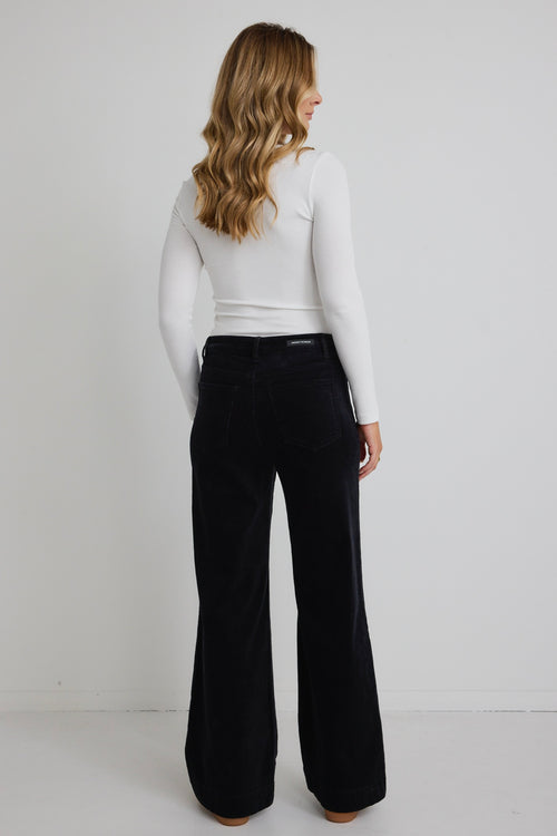 model wears black wide leg jeans