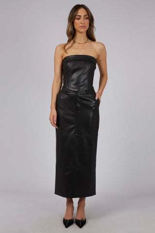 model wears a black leather skirt