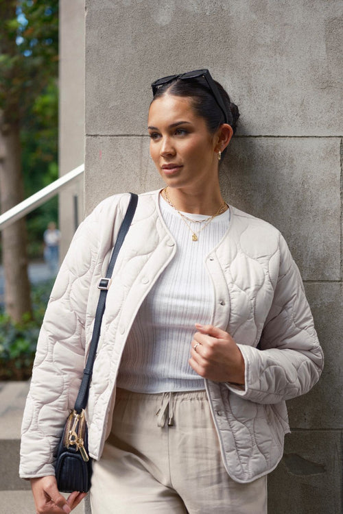 model wears a white puffer jacket