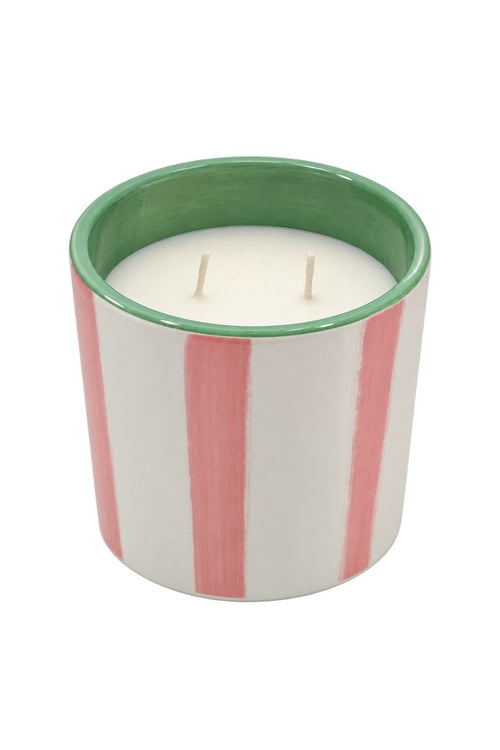A two-wick scented candle in a white ceramic jar with vertical pink stripes and a green interior rim, shown on a plain white background.
