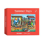 A red jigsaw puzzle box titled 'Summer Days' by artist Graham Young, featuring a colorful illustration of a beachside village scene on the front.