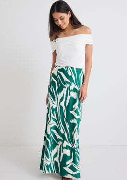 model wears a green print maxi skirt