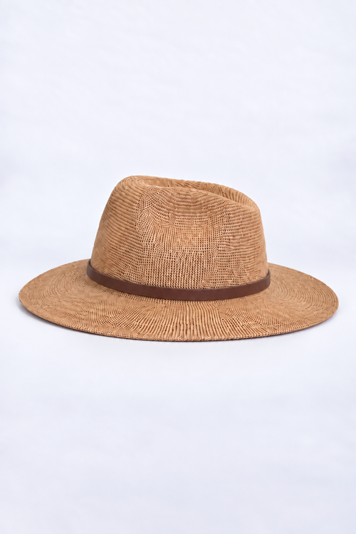 A light brown woven straw fedora hat with a dark brown band around the crown, photographed against a plain white background.