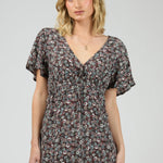 Woman wearing dark purple floral dress