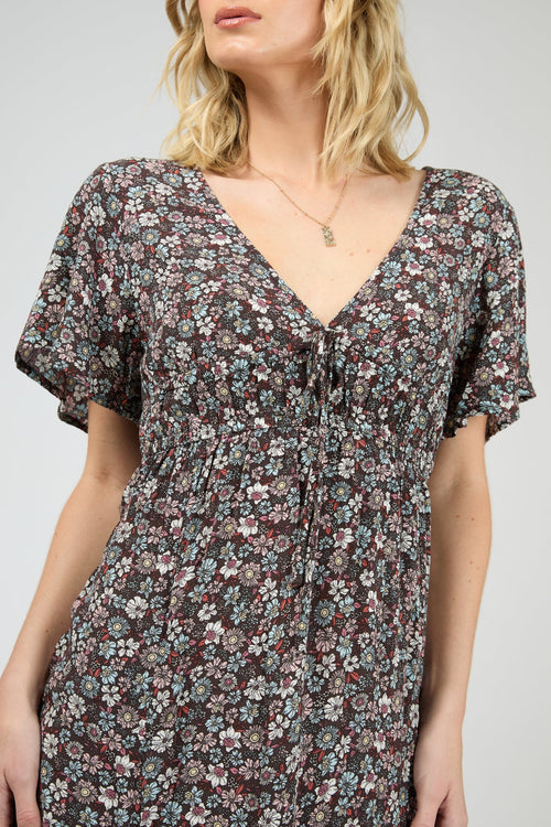 Woman wearing dark purple floral dress