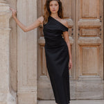 model wears a black one shoulder maxi dress