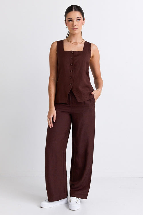 model wears brown linen pants