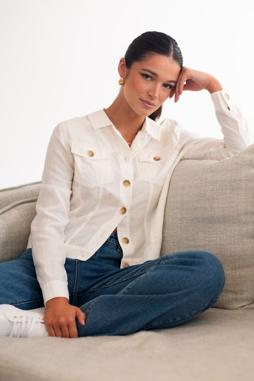 model wears a white linen jacket