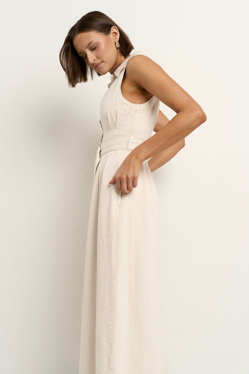 model wears a sleeveless ecru denim midi dress