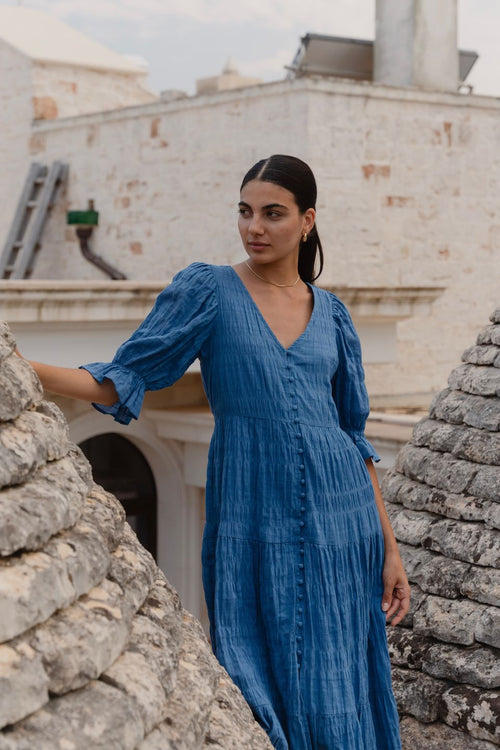 model wears a blue midi dress