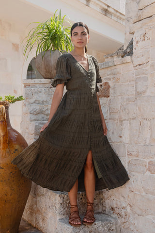 model wears a green midi dress