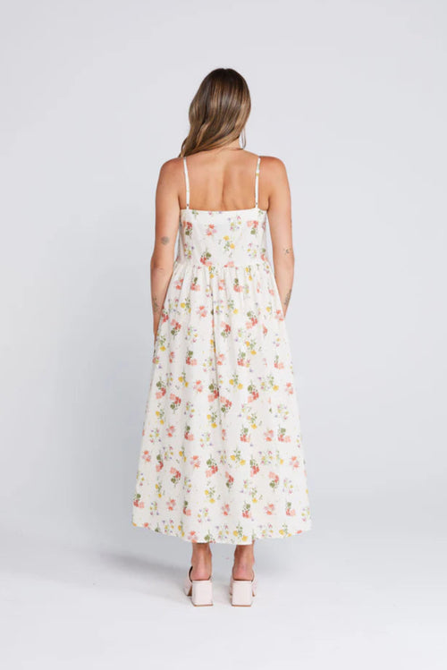 Woman wearing a floral cream long dress