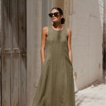 model wears a green linen maxi dress