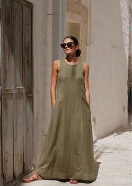 model wears a green linen maxi dress