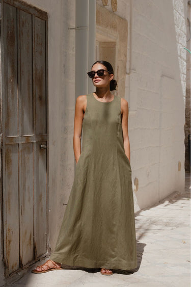 model wears a green linen maxi dress