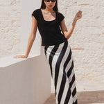 model wears a black white stripe skirt