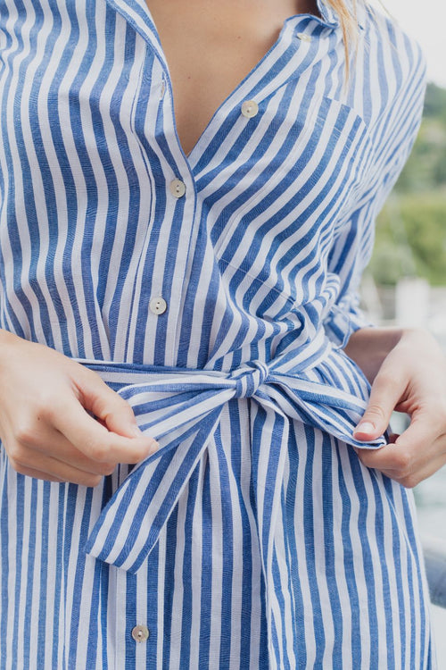 model wears a blue stripe shirt dress