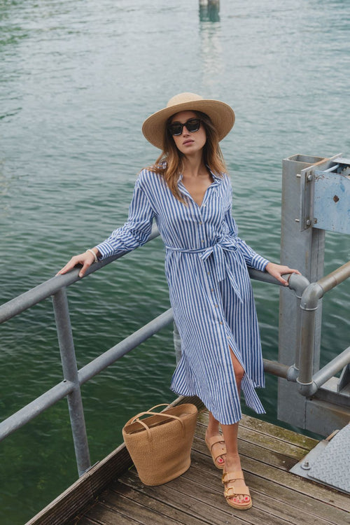 model wears a blue stripe shirt dress