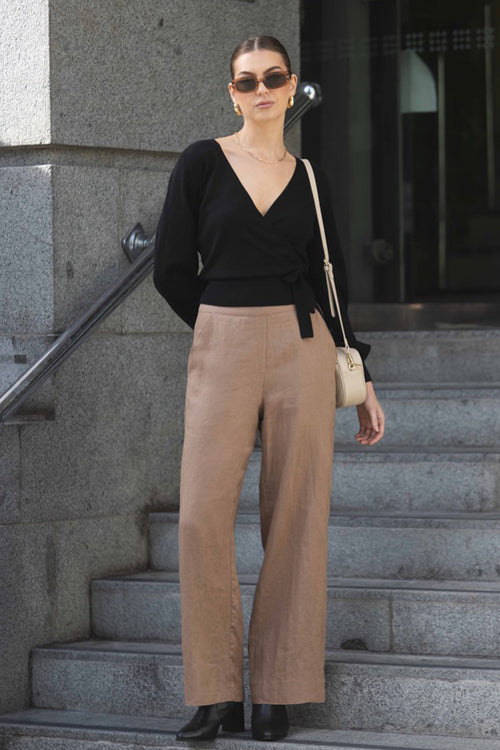 model wears brown linen pants