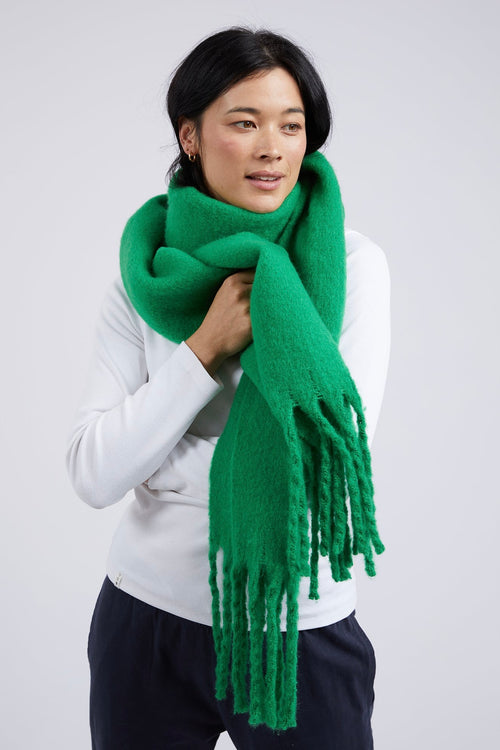 model wears a green scarf