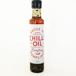 A small glass bottle of House of Dumpling Chilli Oil with a white label and black cap, standing on a white background.