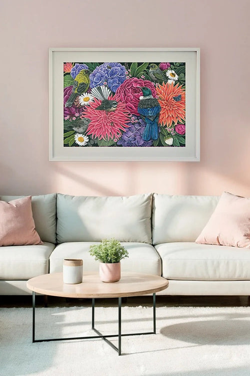 Living room with a white sofa, coffee table, and floral artwork on the wall.