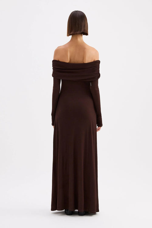 Woman wearing a brown off-shoulder dress on a white background