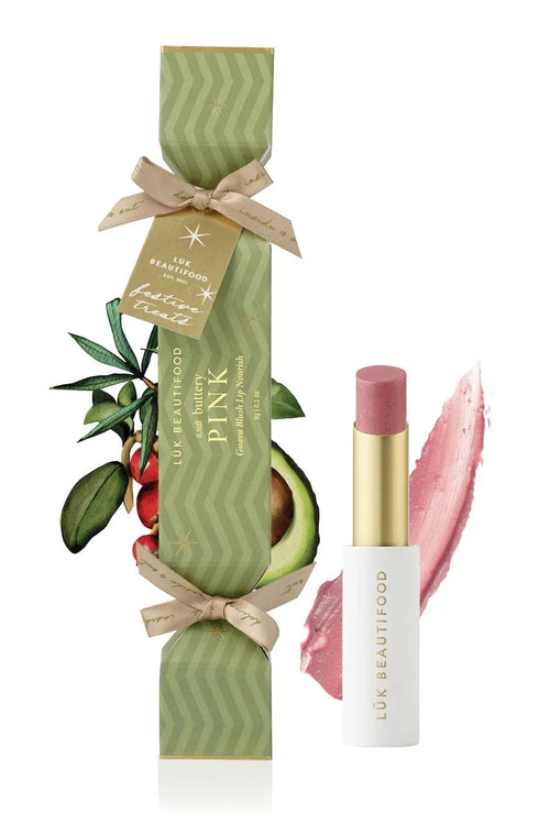 Lipstick with green packaging and avocado illustration on a white background