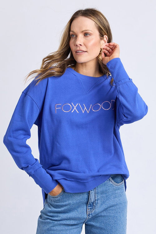 Women wearing blue crewneck and blue jeans