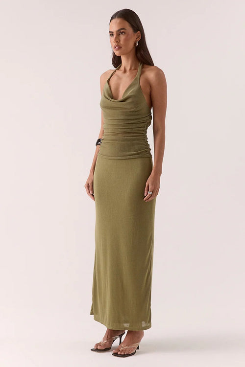 Woman wears a green maxi dress