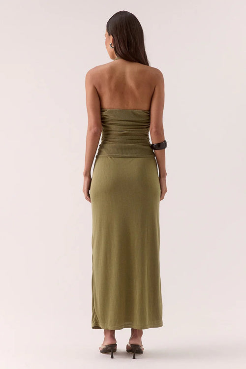 Woman wears a green maxi dress