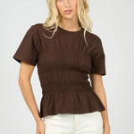 Woman wears a brown ruched top
