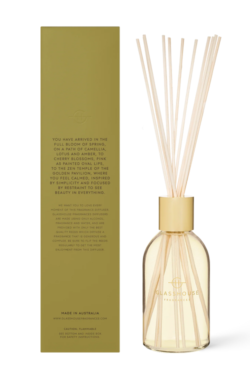 Diffuser bottle with gold cap and clear glass body, accompanied by a green box with text on a white background.