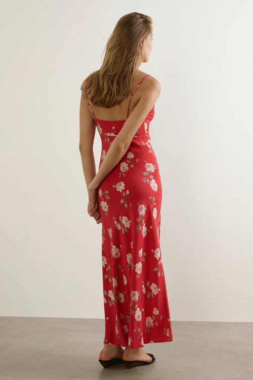 Woman wears a red floral strappy maxi dress