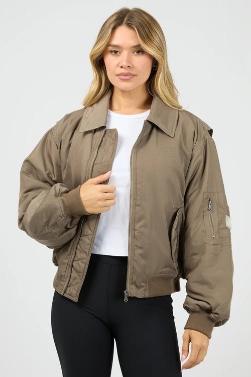 Woman wearing a brown jacket on a white background