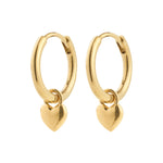 Gold hoop earrings with heart charms on a white background